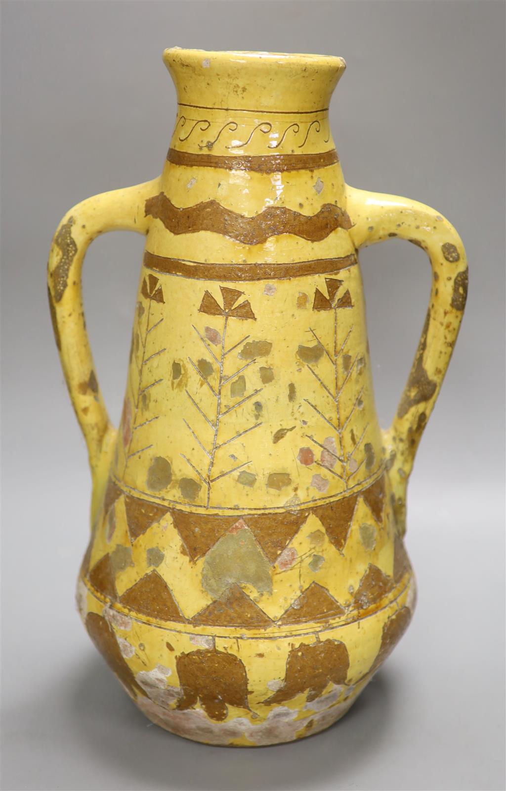 A Continental brown and cream slip decorated two handled vase, height 46cm (a.f.)